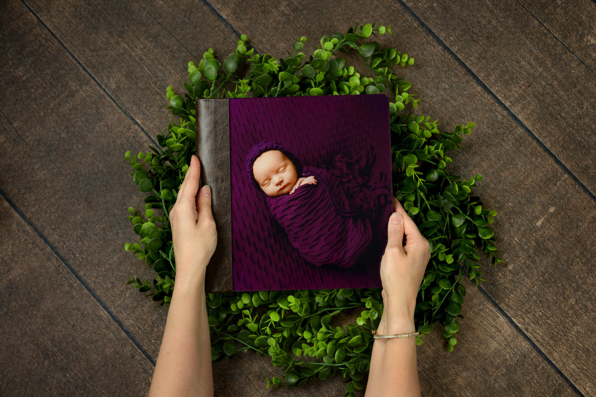 Halifax newborn photographer hands holding an heirloom album