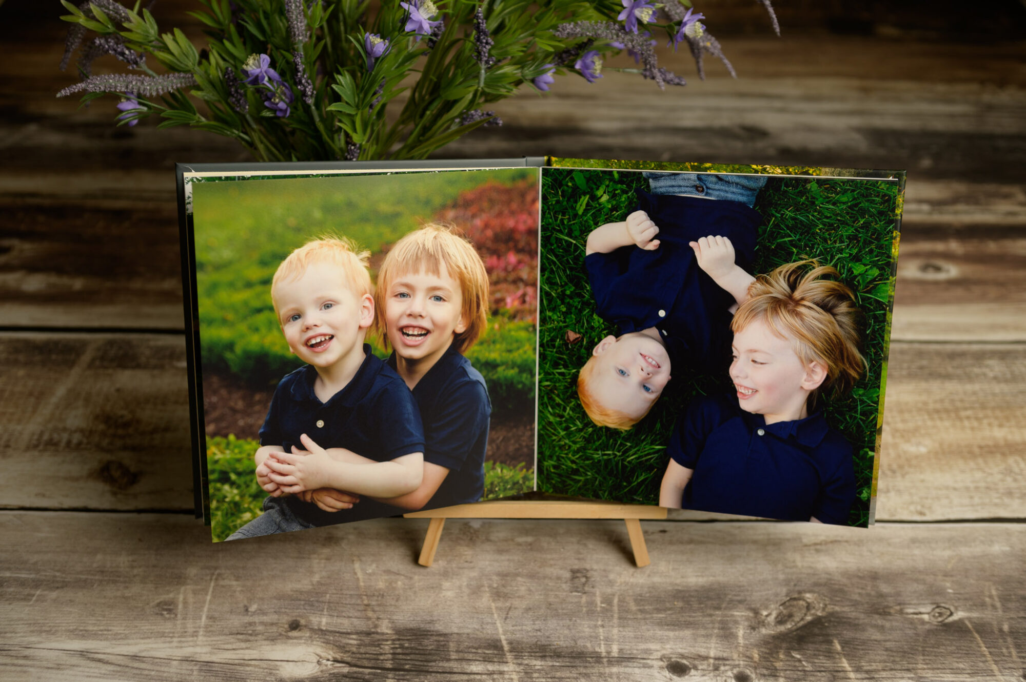 custom photo album on a wooden easel opened to photos of two children who are brothers