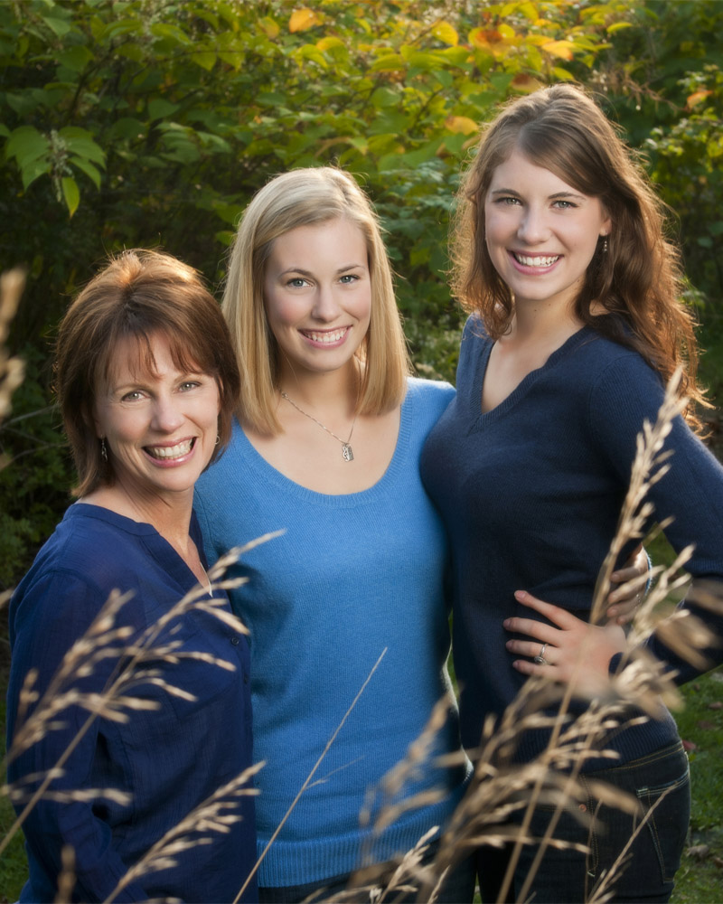 Mother and two daughters posing for a family photo