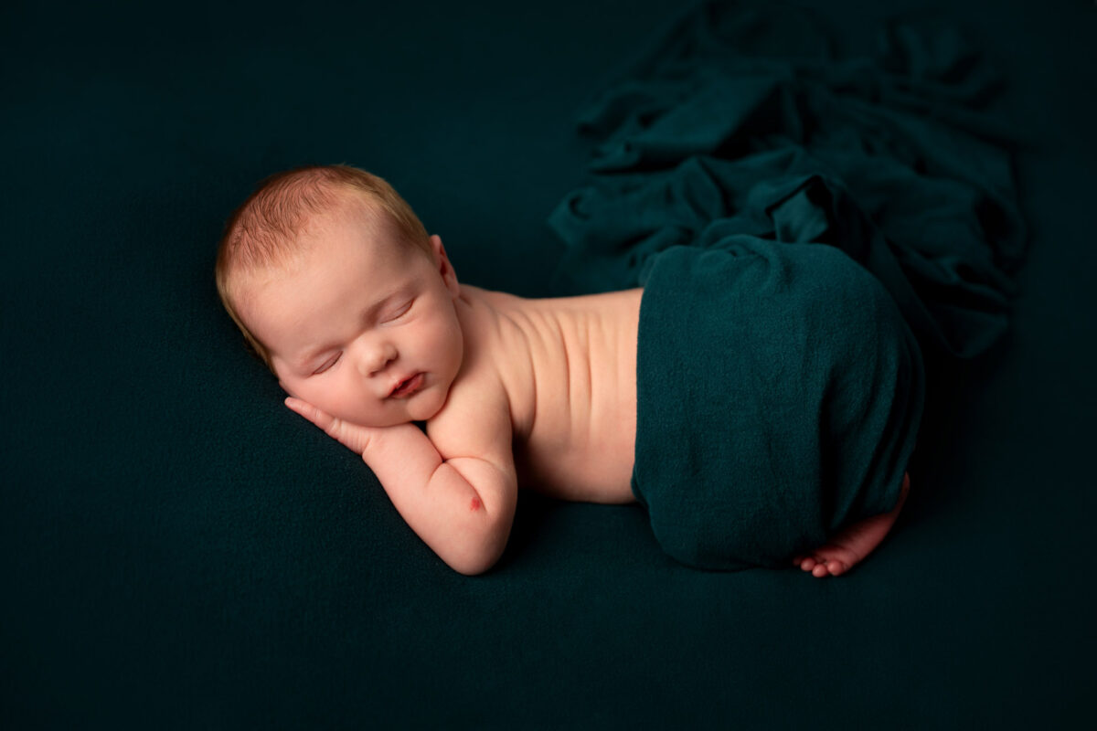 Newborn baby on dark green background, Halifax