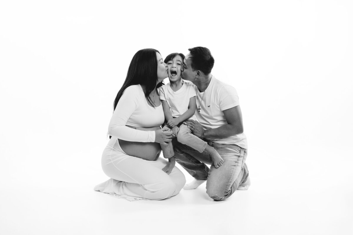 Family maternity session photographed on a white background
