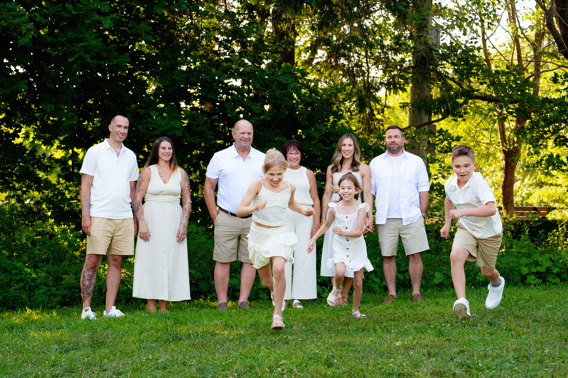 Fun extended family photoshoot with kids running towards the camera