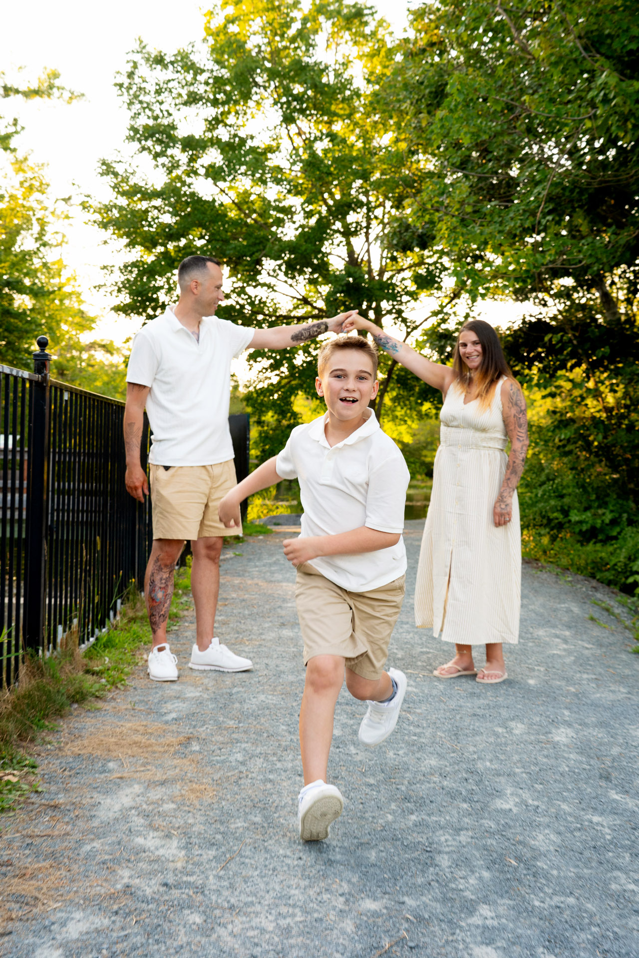 Fun family of 3 with kid running towards the camera